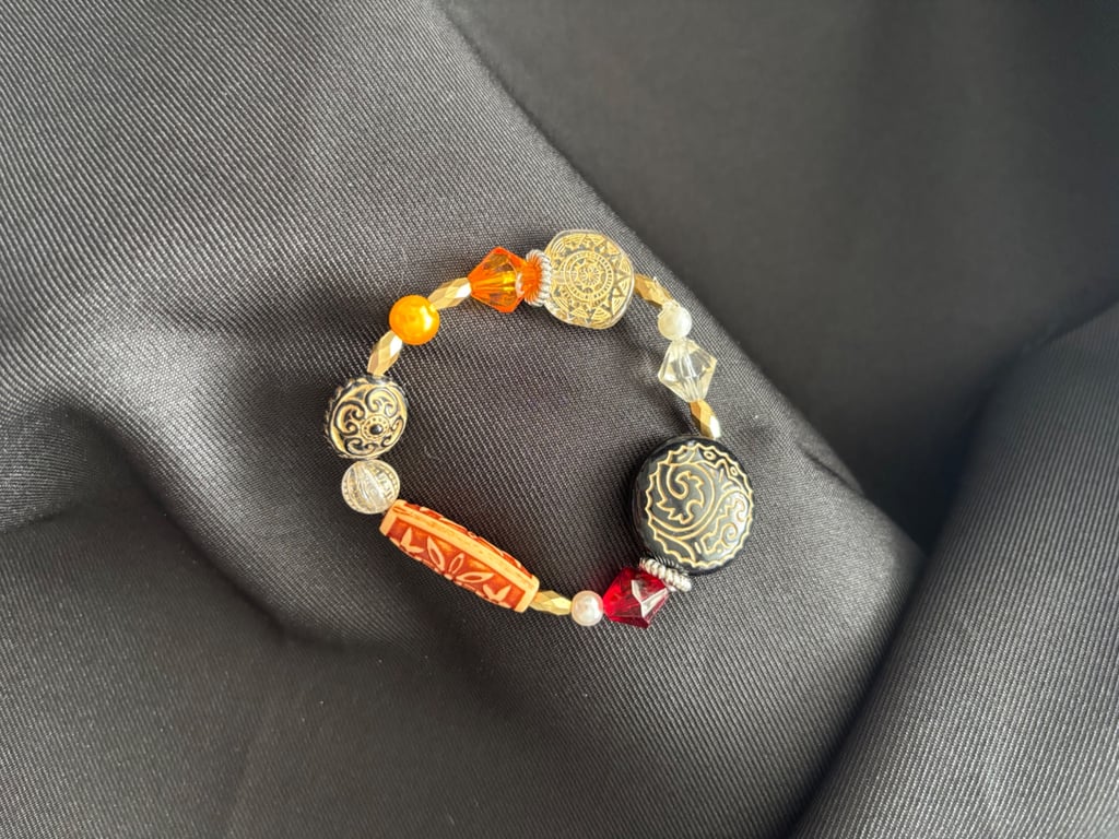 Handmade earth coloured bracelet, 16cm, reds, gold, orange beadwork 