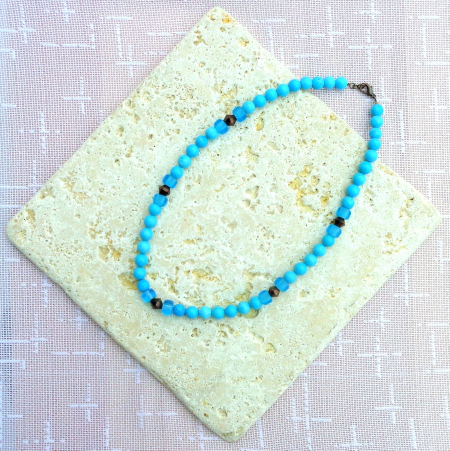 Necklace of turquoise howlite beads with copper accents