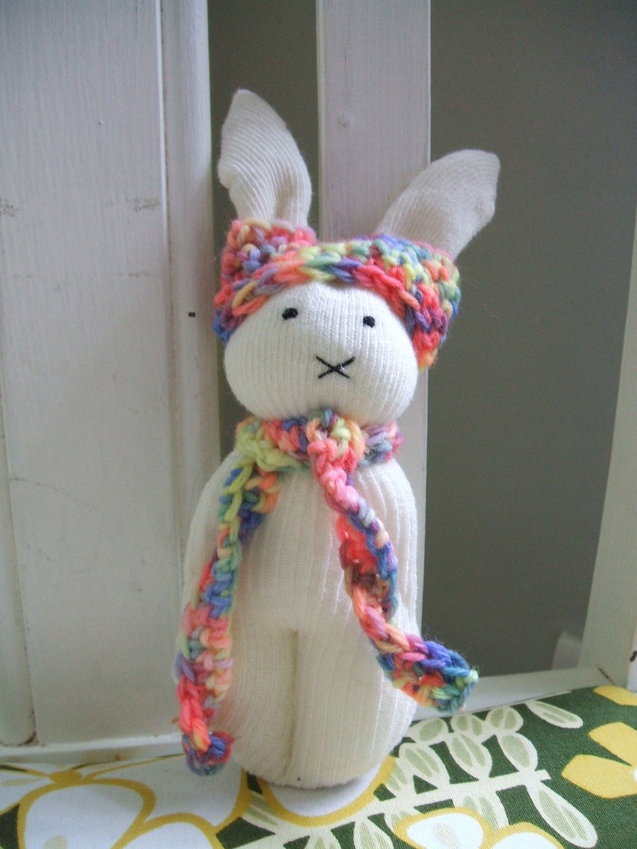 Cute bunny soft toy with rainbow scarf and hat