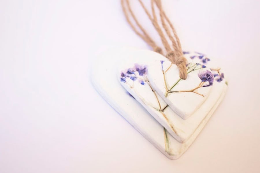 Three handmade hanging clay hearts