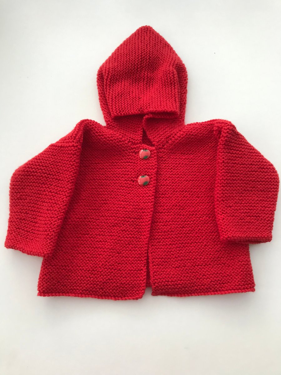 Hand knitted baby jacket with a pixie hood