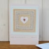 Hand-stitched miniature embroidery worked on heart mounted on greeting card