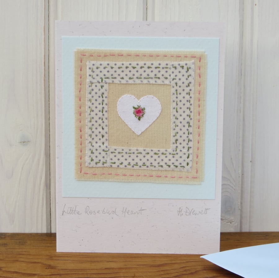 Hand-stitched miniature embroidery worked on heart mounted on greeting card