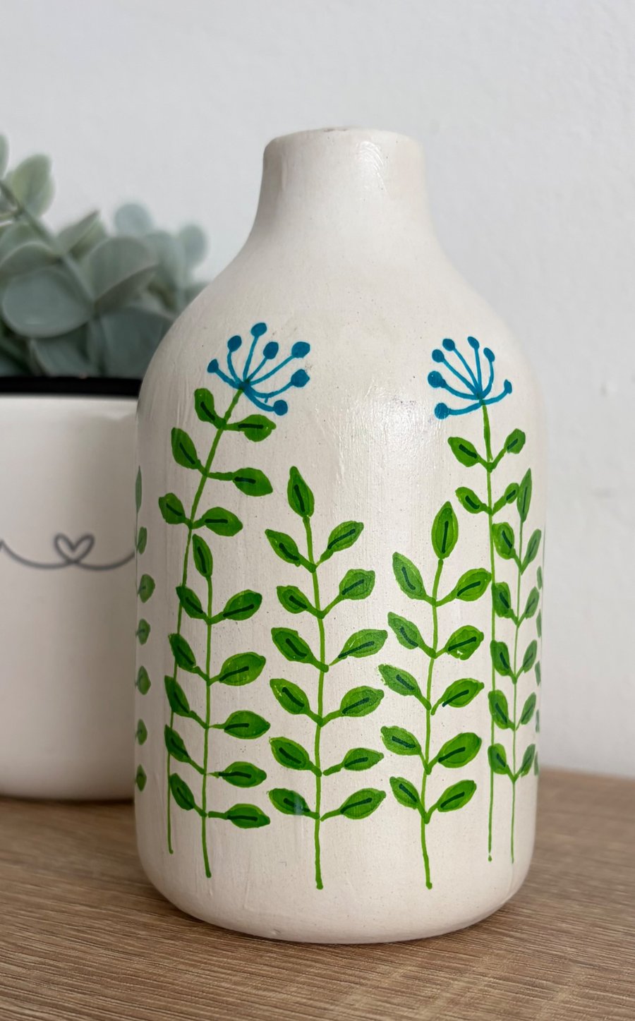 Small ceramic with hand drawn doodles. 