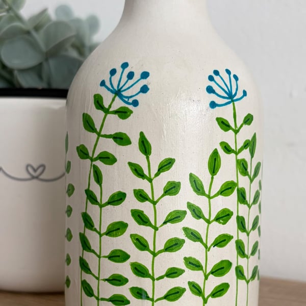 Small ceramic with hand drawn doodles. 