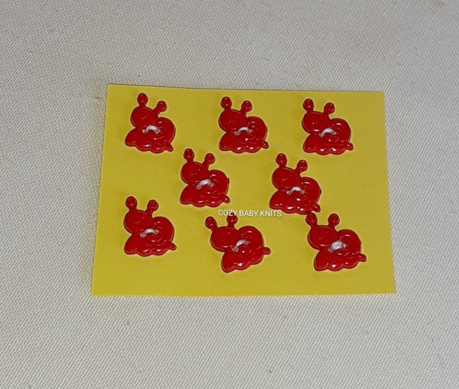 RED SNAIL SHAPED  BUTTONS WITH TWO HOLES FOR FIXING