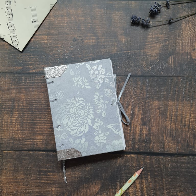 Handmade floral A6 journal, with Coptic stitching and leather detail
