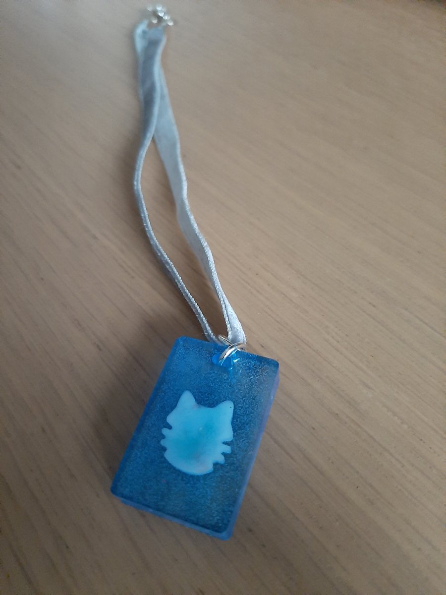 Unique blue oblong pendant with a cat design resin  with ribbon necklace 