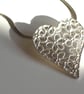 Silver heart necklace with daisy pattern. - Image 1