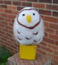 Snowy Owl on a yellow wooden building block