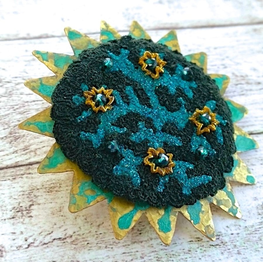 Embroidery embellished verdigris patinated brass brooch.