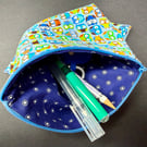 Medium zipped pouch with colourful owls on light blue