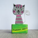 Wooden cat ornament, silver and pink striped cat.
