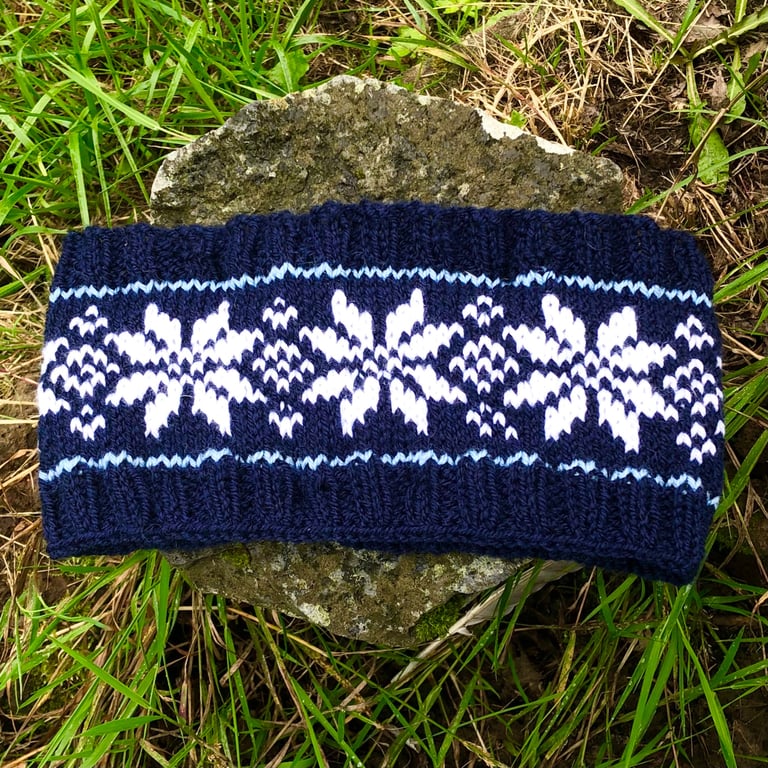 Hand knitted headband featuring Scandinavian pattern. Fleece lined 