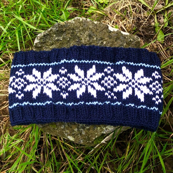 Hand knitted headband featuring Scandinavian pattern. Fleece lined 