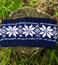 Hand knitted headband featuring Scandinavian pattern. Fleece lined 