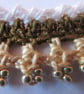 A crocheted necklace in white, coffee and cream cotton with edging of gold beads - Image 3