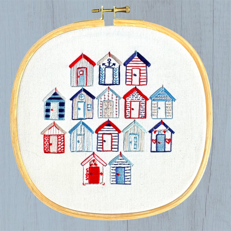 An embroidered gift, a seaside escape, beach huts framed  artwork 
