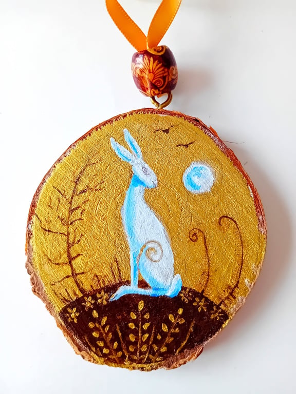 gold wood slice with a white hare