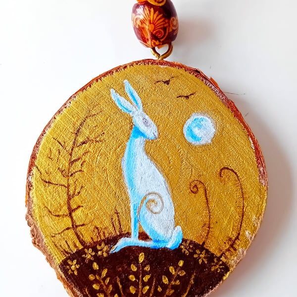 gold wood slice with a white hare