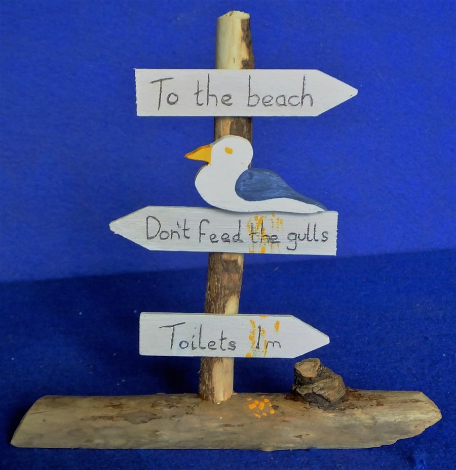 SIGN TO THE BEACH, CAR PARK, CAFE, DON'T FEED THE GULLS, TOILETS