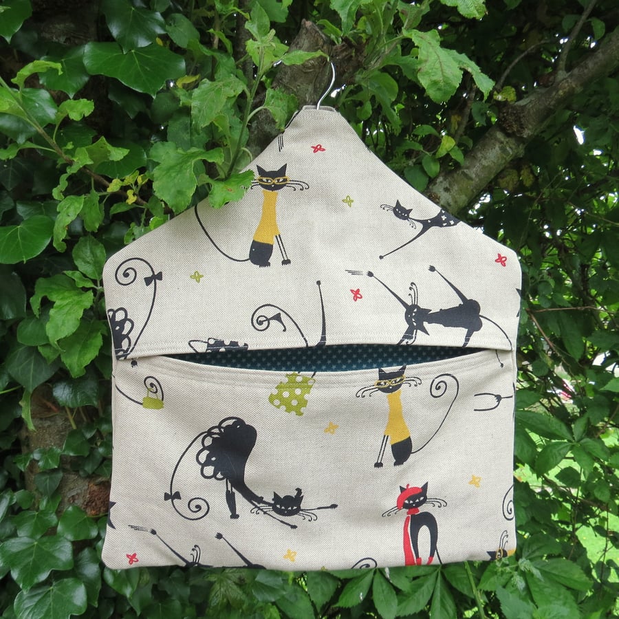 A peg bag with a quirky cats design.  Peg storage.