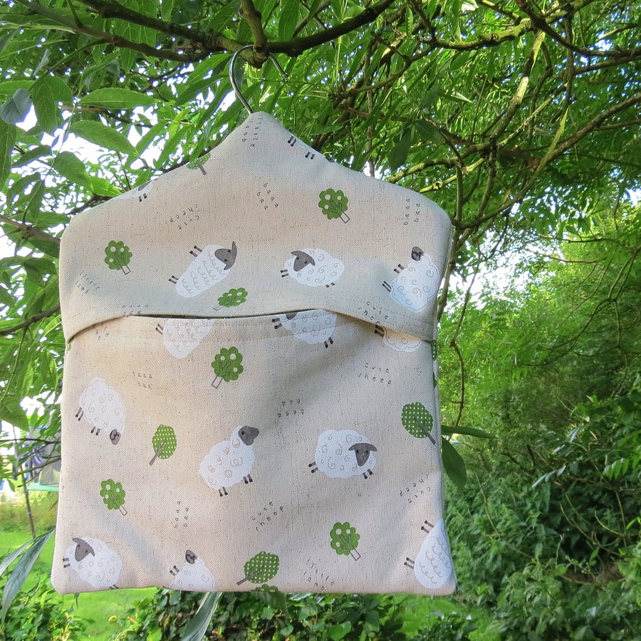 A peg bag with a sheep design.  Peg storage.  