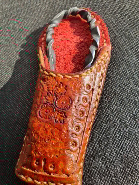 Bottle opener and leather sheath. Real leather and steal