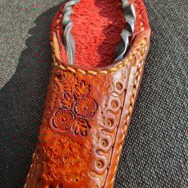 Bottle opener and leather sheath. Real leather and steal
