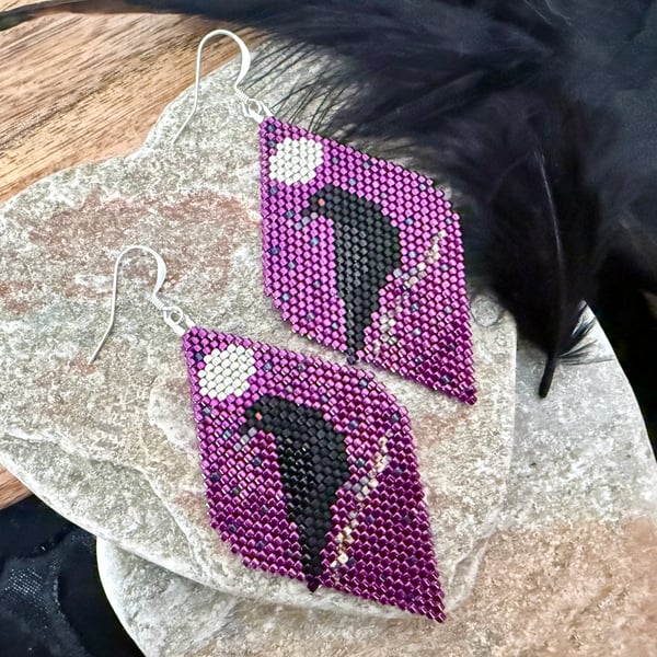 Black raven beadwork earrings in metallic plum