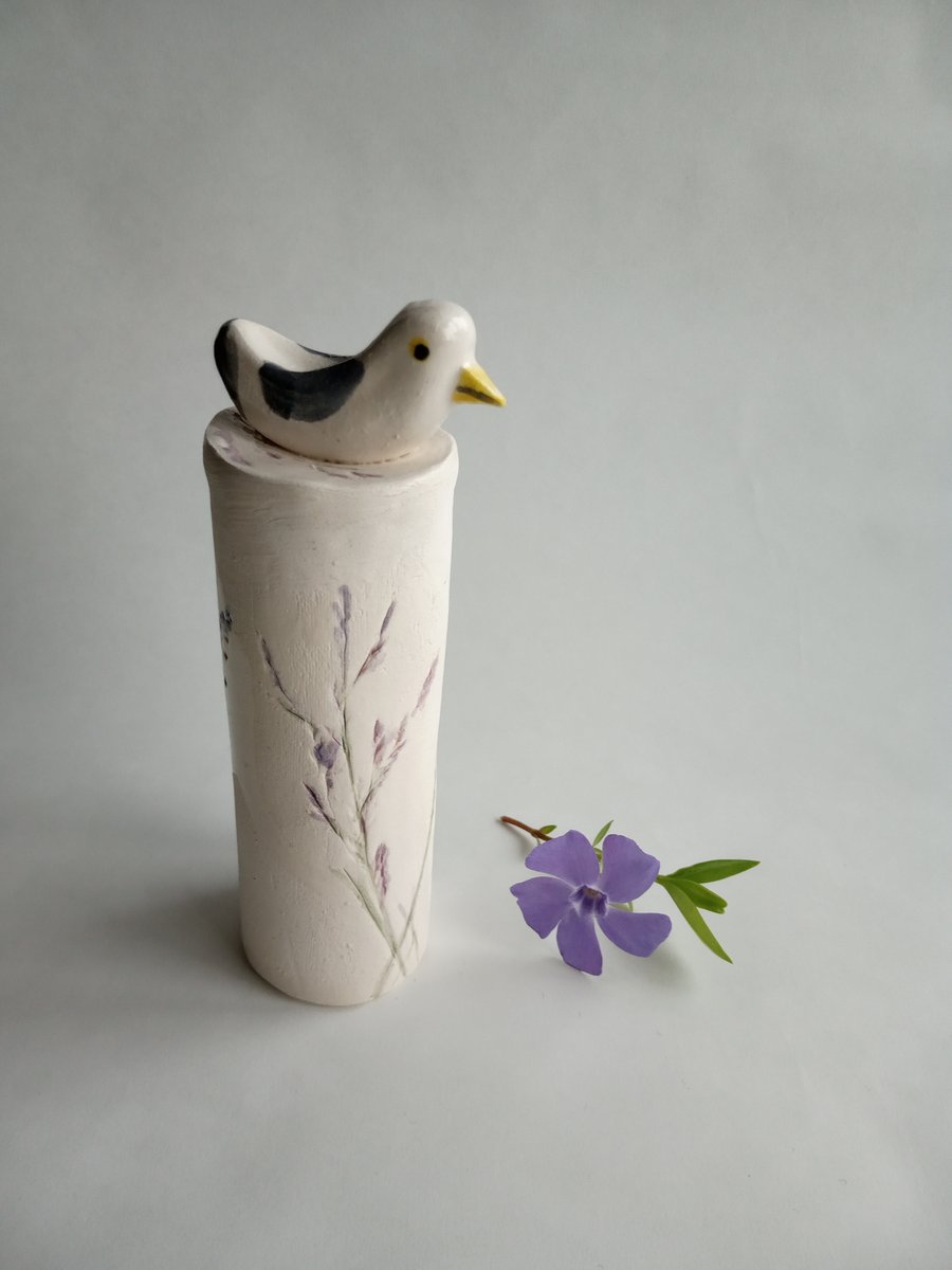 ceramic seagull on a floral plinth