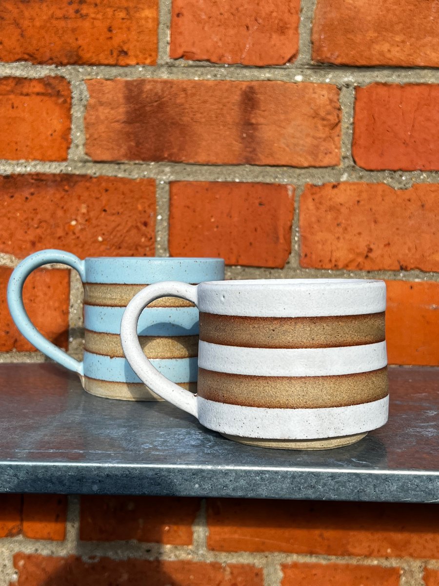 Hand made blue or white striped pottery mug. Green also available