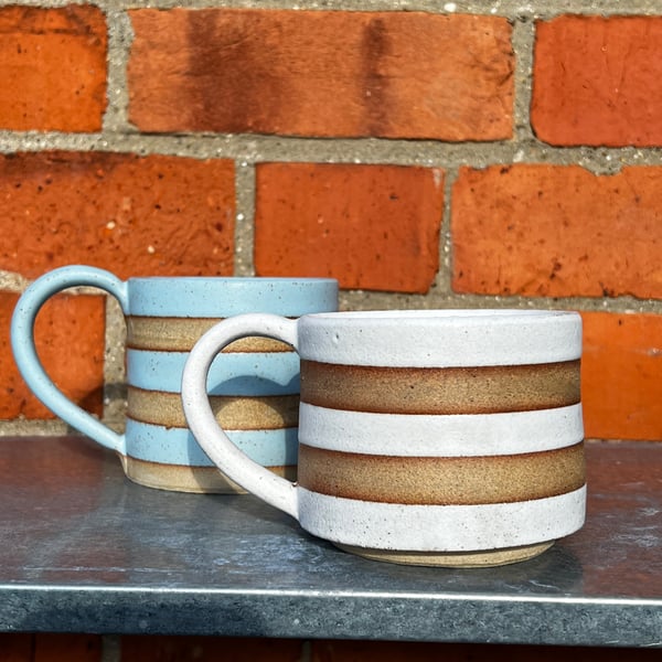 Hand made blue or white striped pottery mug. Green also available