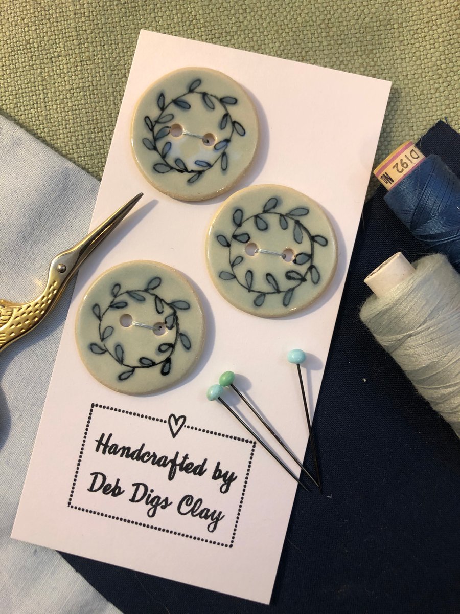 Set of 3 large handcrafted pale blue ceramic buttons with a hand-drawn design