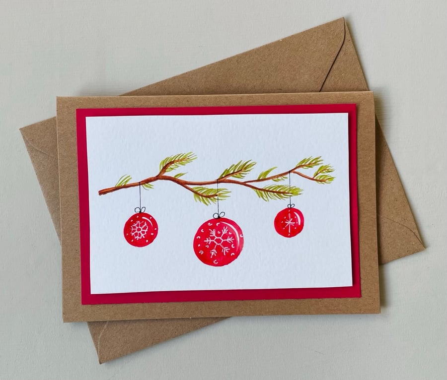 Christmas card, original red scandi style baubles on fir tree branch