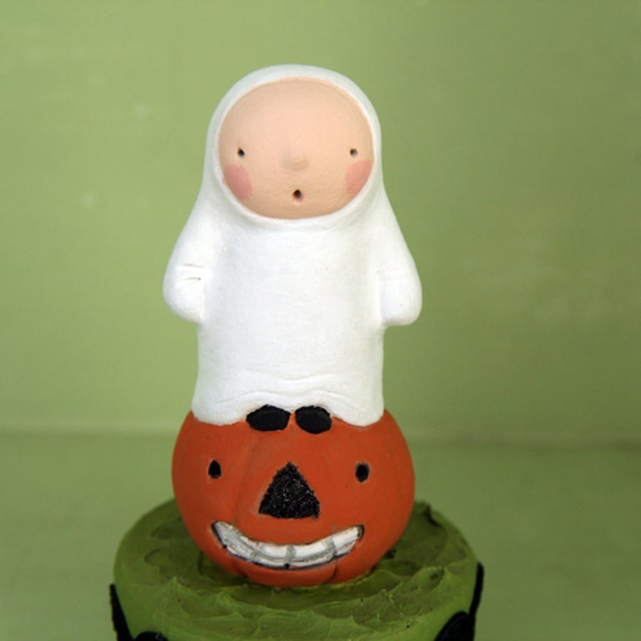 Primitive folk art Halloween ghost figure on a pumpkin. Little box for tiny gift