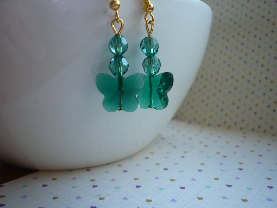 TEAL GREEN AND GOLD FACETED GLASS BUTTERFLY EARRINGS.