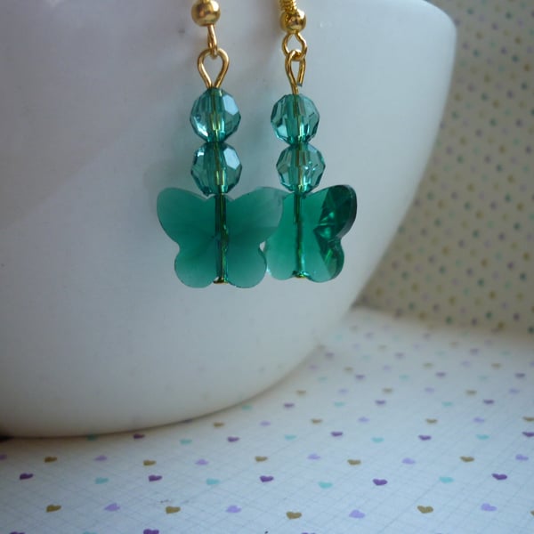 TEAL GREEN AND GOLD FACETED GLASS BUTTERFLY EARRINGS.