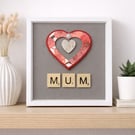 Celebrate a special mum with this handmade framed “MUM” artwork, featuring a lay