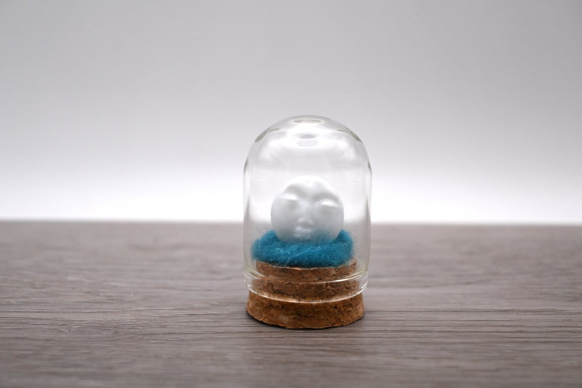 small glass man in the moon