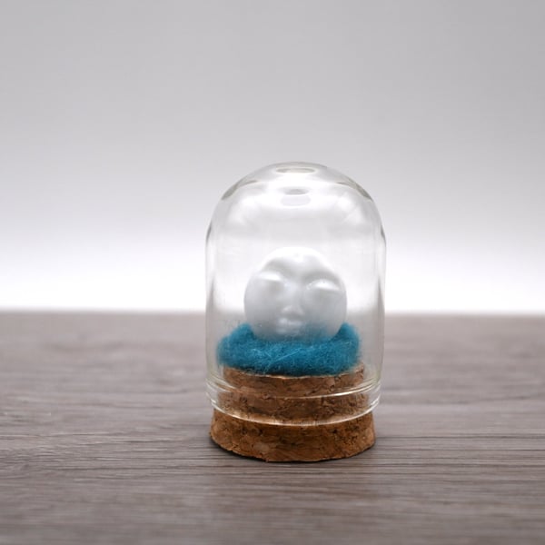 small glass man in the moon
