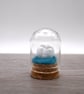 small glass man in the moon