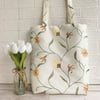 Floral tote bag in embroidered cream fabric with twining floral stem pattern