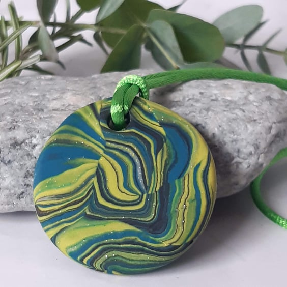 Brightly coloured round polymer clay pendant