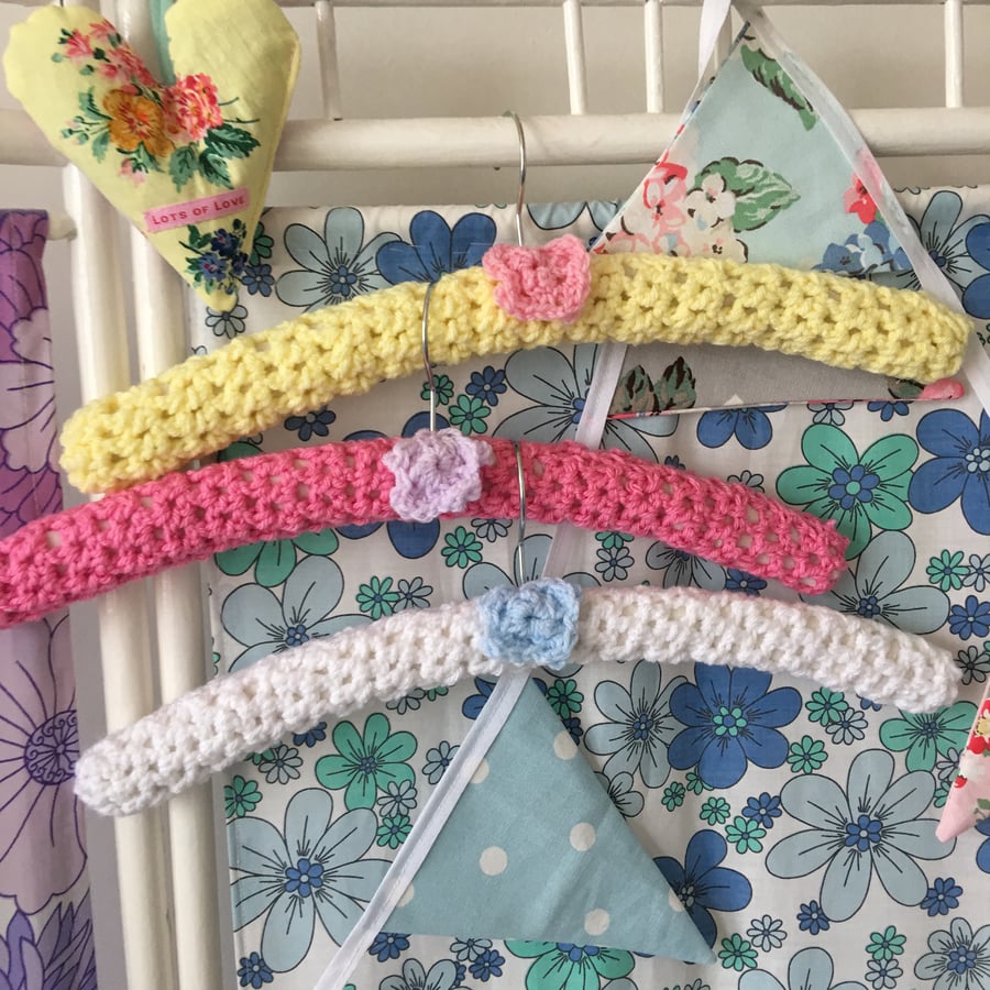 3 crochet covered hangers with crochet flowers