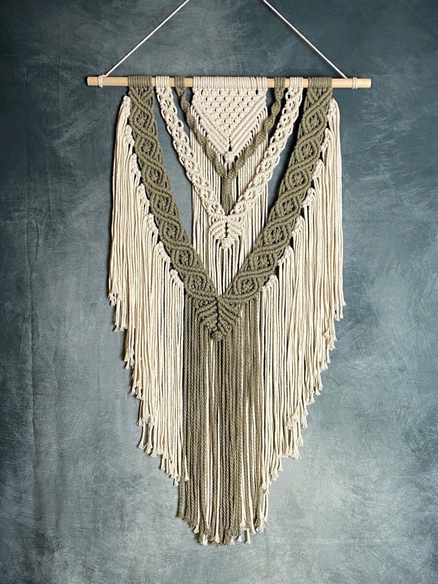 Macrame wall hanging with intricate knot design, sage green and beige colours