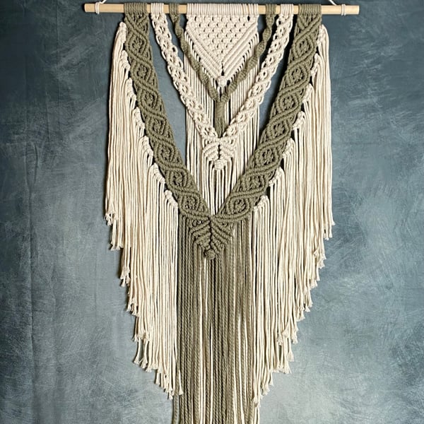 Macrame wall hanging with intricate knot design, sage green and beige colours