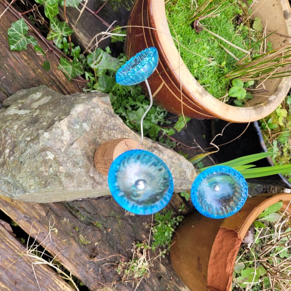 trio of blue resin flowers set in oak