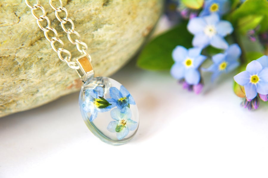 inspirational resin necklace with real forget me not flowers