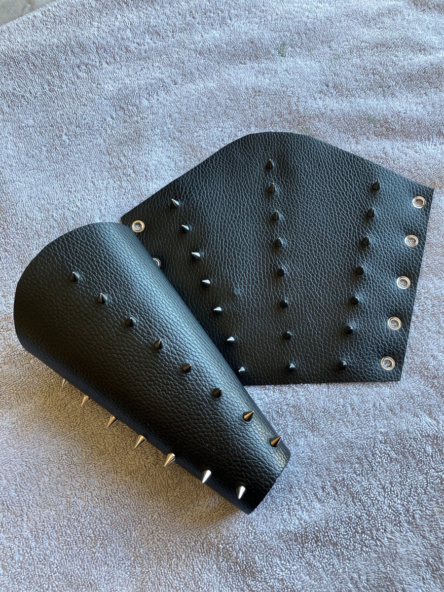 Large pair of black leather bracers with 3 rows of Chrome coloured spikes